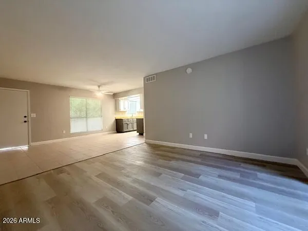 a view of empty room with wooden floor