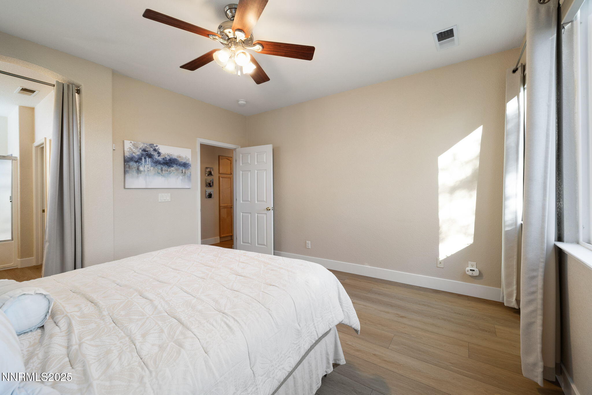 10560 Vista Alta Drive Reno, NV 89521 - Photo 15 of 25 a bedroom with a large bed and a chandelier