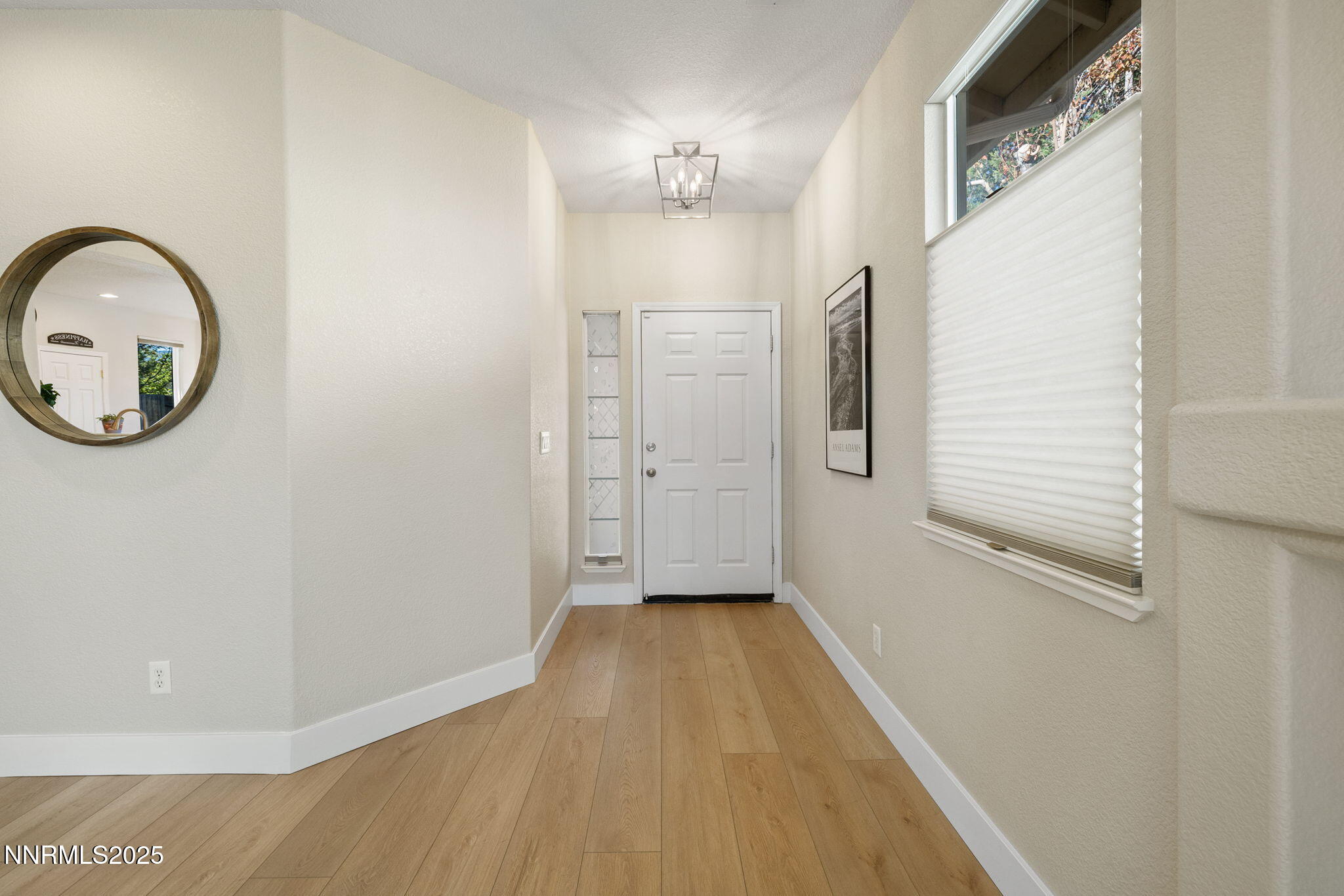10560 Vista Alta Drive Reno, NV 89521 - Photo 4 of 25 a view of a hallway with wooden floor