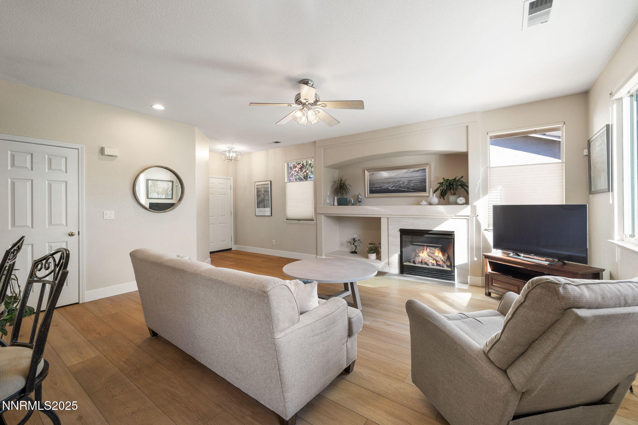 10560 Vista Alta Drive Reno, NV 89521 - Photo 7 of 25 a living room with furniture a fireplace and a flat screen tv