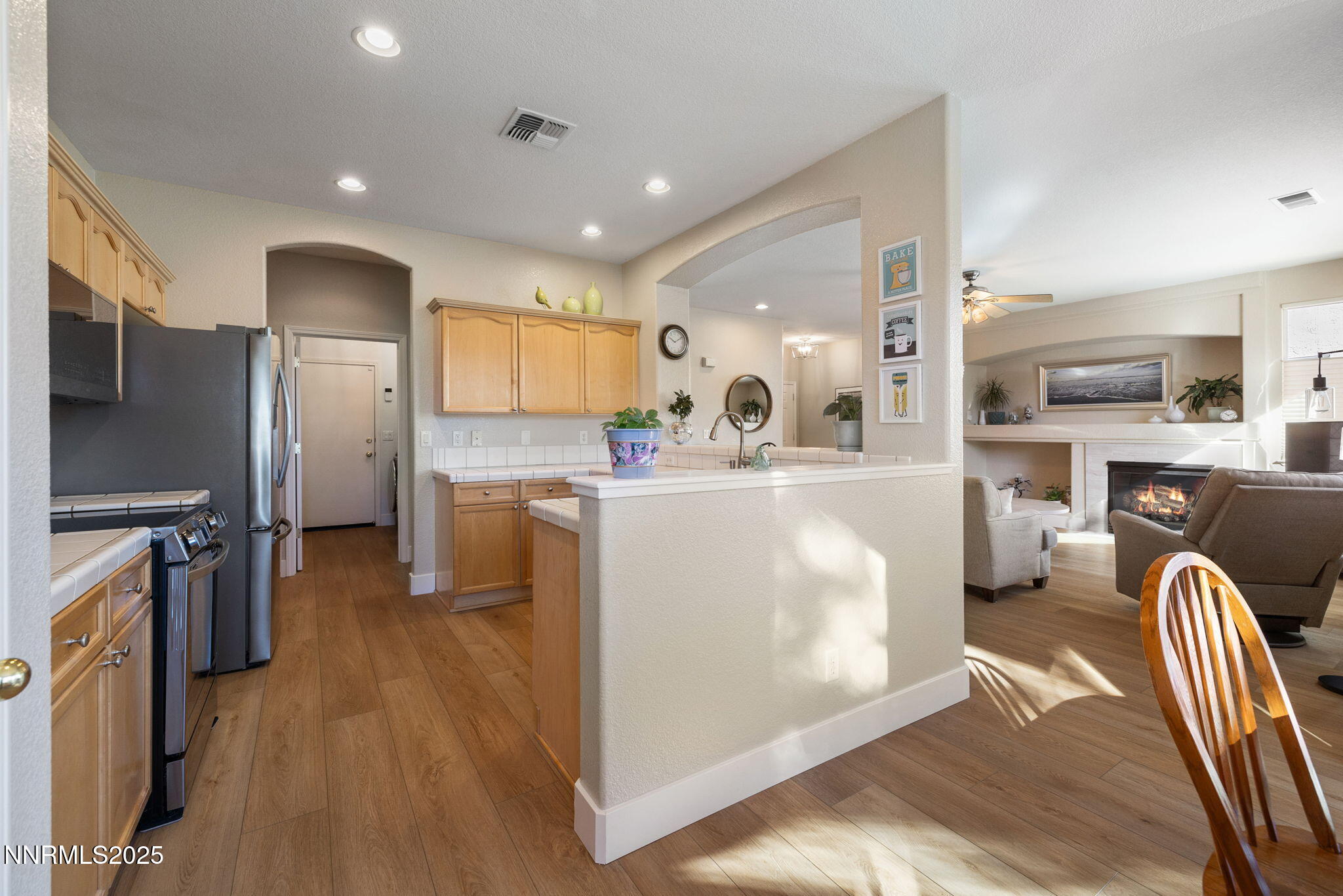 10560 Vista Alta Drive Reno, NV 89521 - Photo 9 of 25 a kitchen with stainless steel appliances granite countertop a refrigerator stove microwave and sink