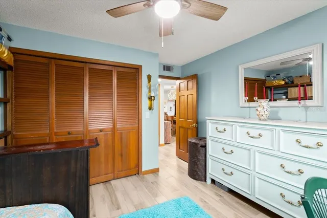 a kitchen with a wooden floor and cabinets