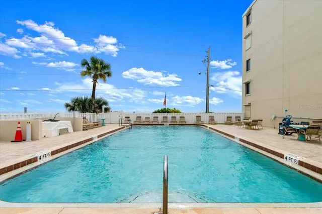 a view of a swimming pool with outdoor seating