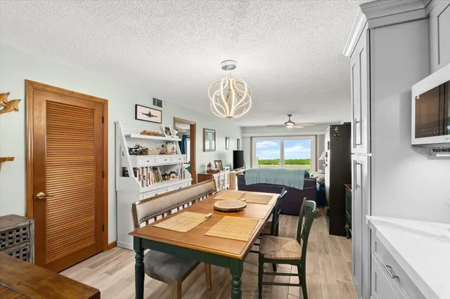 a view of a dining room with furniture a rug and wooden floor