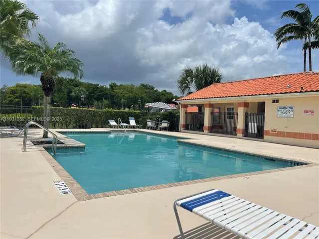 a view of a house with swimming pool and a yard