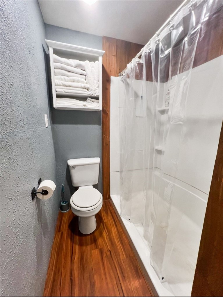 1188 Private 6030 Cameron, TX 76520 - Photo 12 of 28 Bathroom with a shower, toilet, wood finished floors
