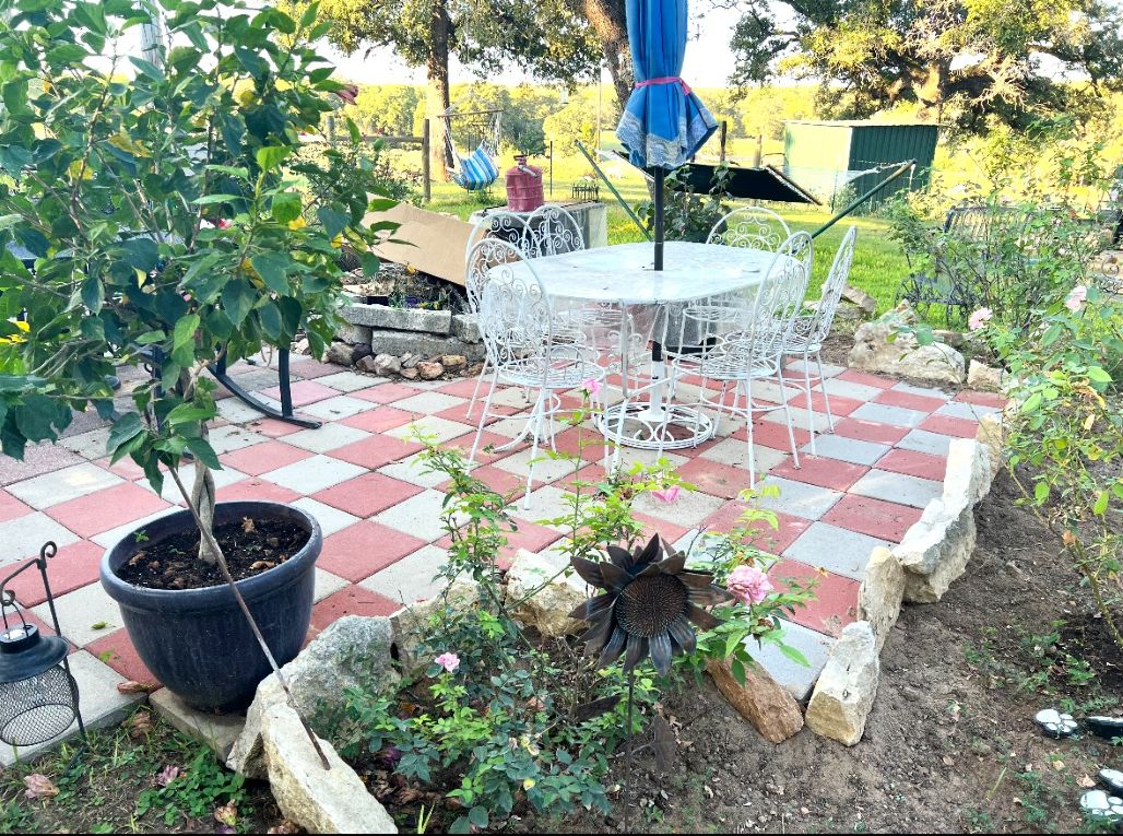 1188 Private 6030 Cameron, TX 76520 - Photo 22 of 28 a view of a backyard with plants and fountain