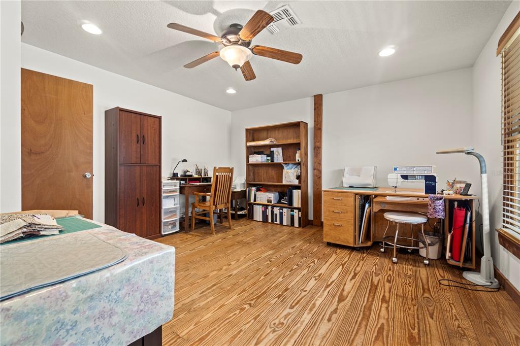 4292 Southwest 73rd Trail Bushnell, FL 33513 - Photo 35 of 88 a bedroom with a bed and a book shelf