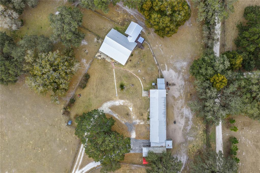 4292 Southwest 73rd Trail Bushnell, FL 33513 - Photo 78 of 88 an aerial view of a house with a yard and large trees