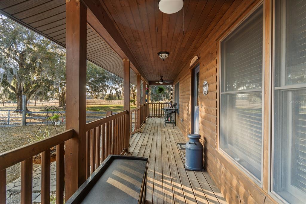 4292 Southwest 73rd Trail Bushnell, FL 33513 - Photo 10 of 88 a view of a balcony with chairs and wooden floor