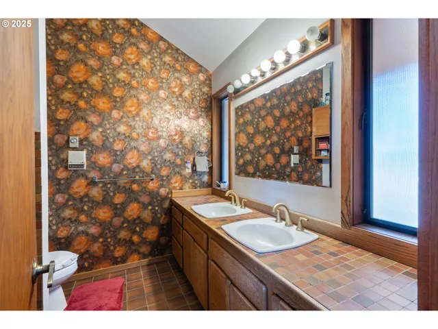 a bathroom with sink vanity granite and a shower