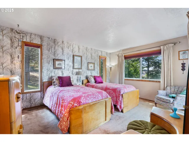 a bed room with a bed and a large window