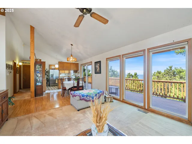 a living room with patio furniture and a chandelier