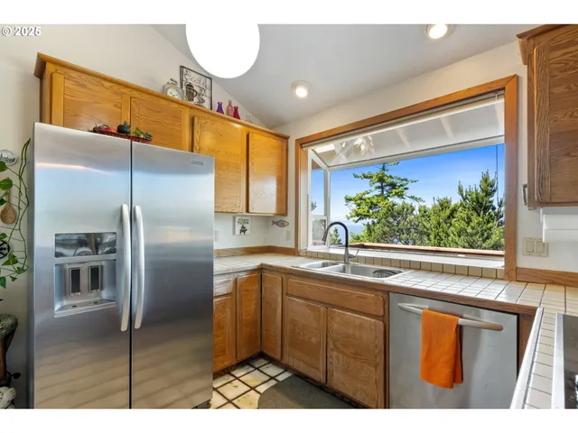 a kitchen with stainless steel appliances a sink and a refrigerator