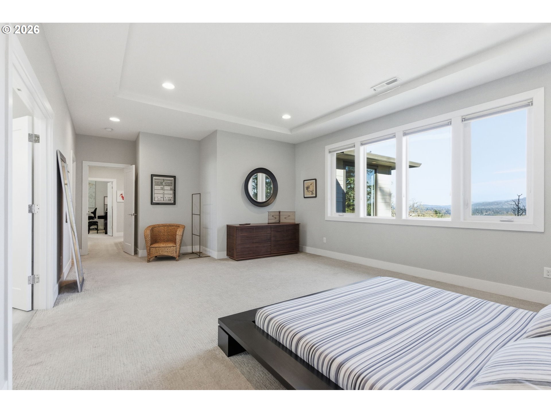 2123 South Military Road Portland, OR 97219 - Photo 25 of 47 a spacious bedroom with a bed a mirror and a window