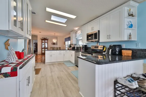 a kitchen with stainless steel appliances granite countertop a refrigerator sink and cabinets