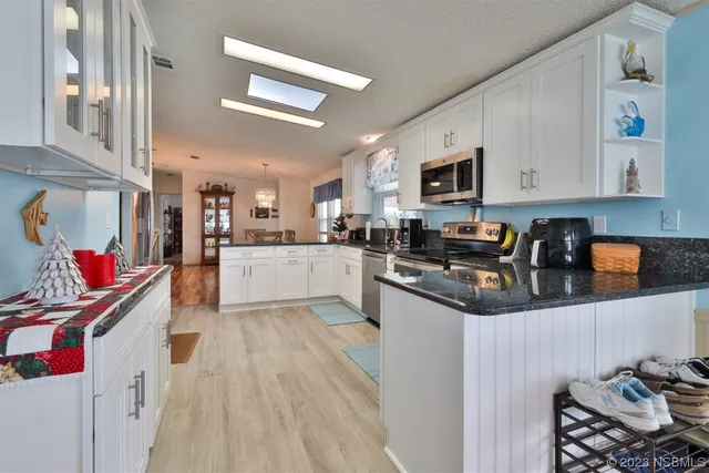 a kitchen with stainless steel appliances granite countertop a refrigerator sink and cabinets