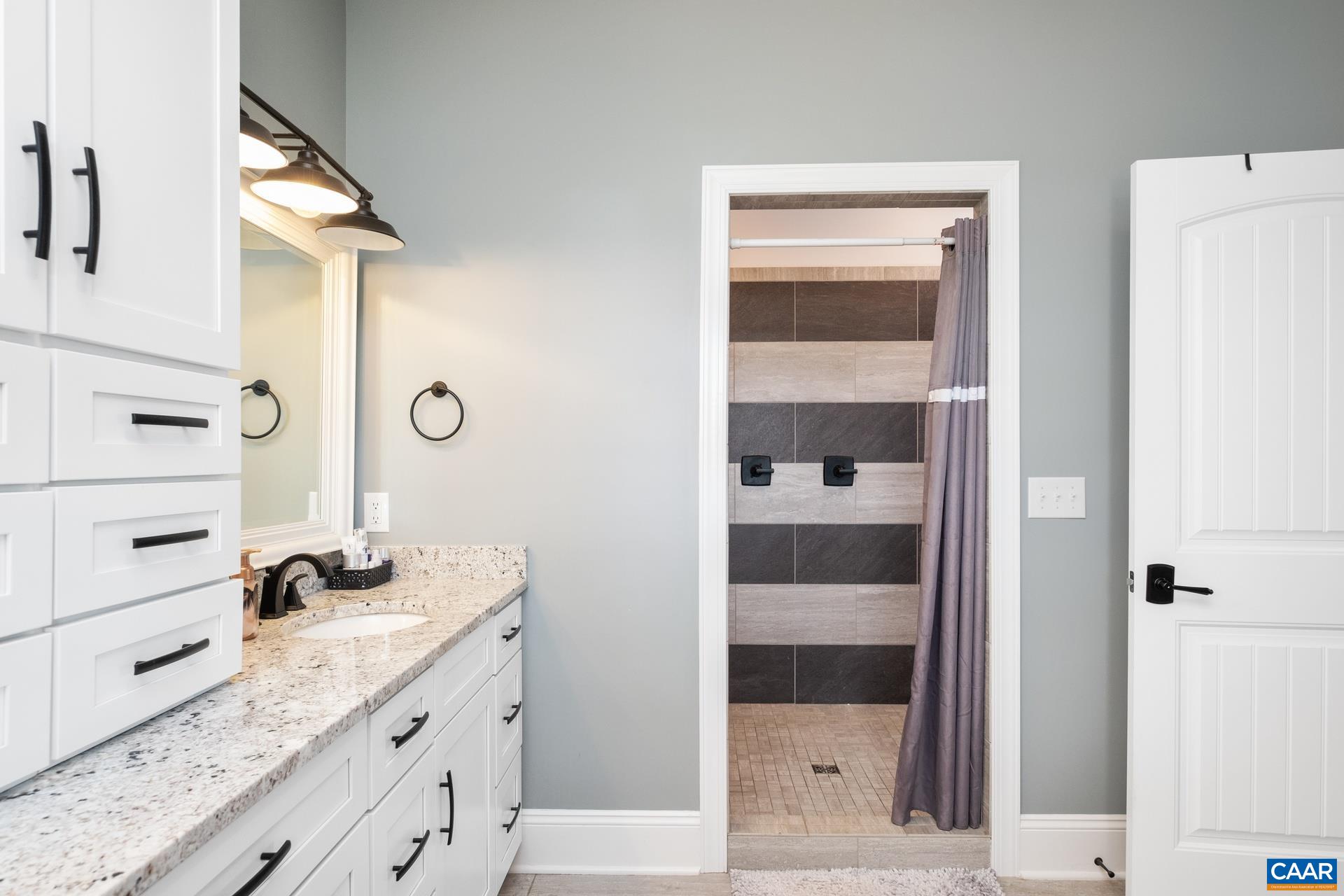 728 Long Meadow Road Fishersville, VA 22939 - Photo 18 of 52 a bathroom with a granite countertop sink and a mirror