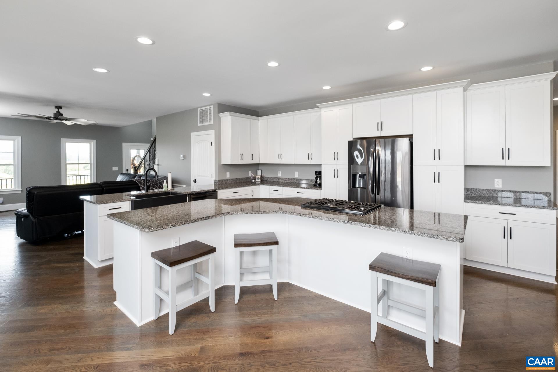 728 Long Meadow Road Fishersville, VA 22939 - Photo 7 of 52 a kitchen with stainless steel appliances granite countertop a refrigerator a stove a sink a dining table and chairs