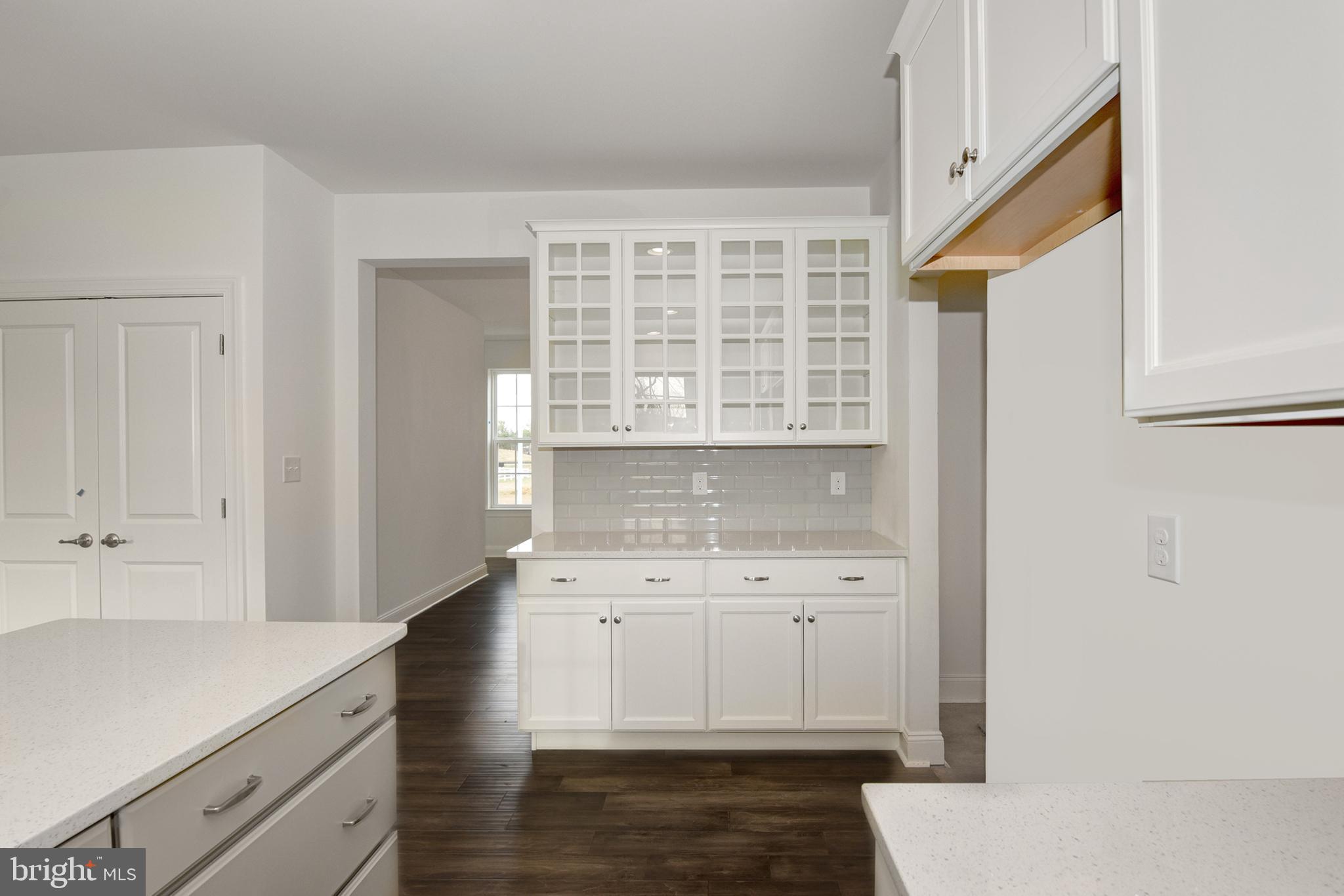 33 Seldon Drive, Unit 3 Smyrna, DE 19977 - Photo 11 of 24 a kitchen with a sink dishwasher a stove and white cabinets with wooden floor