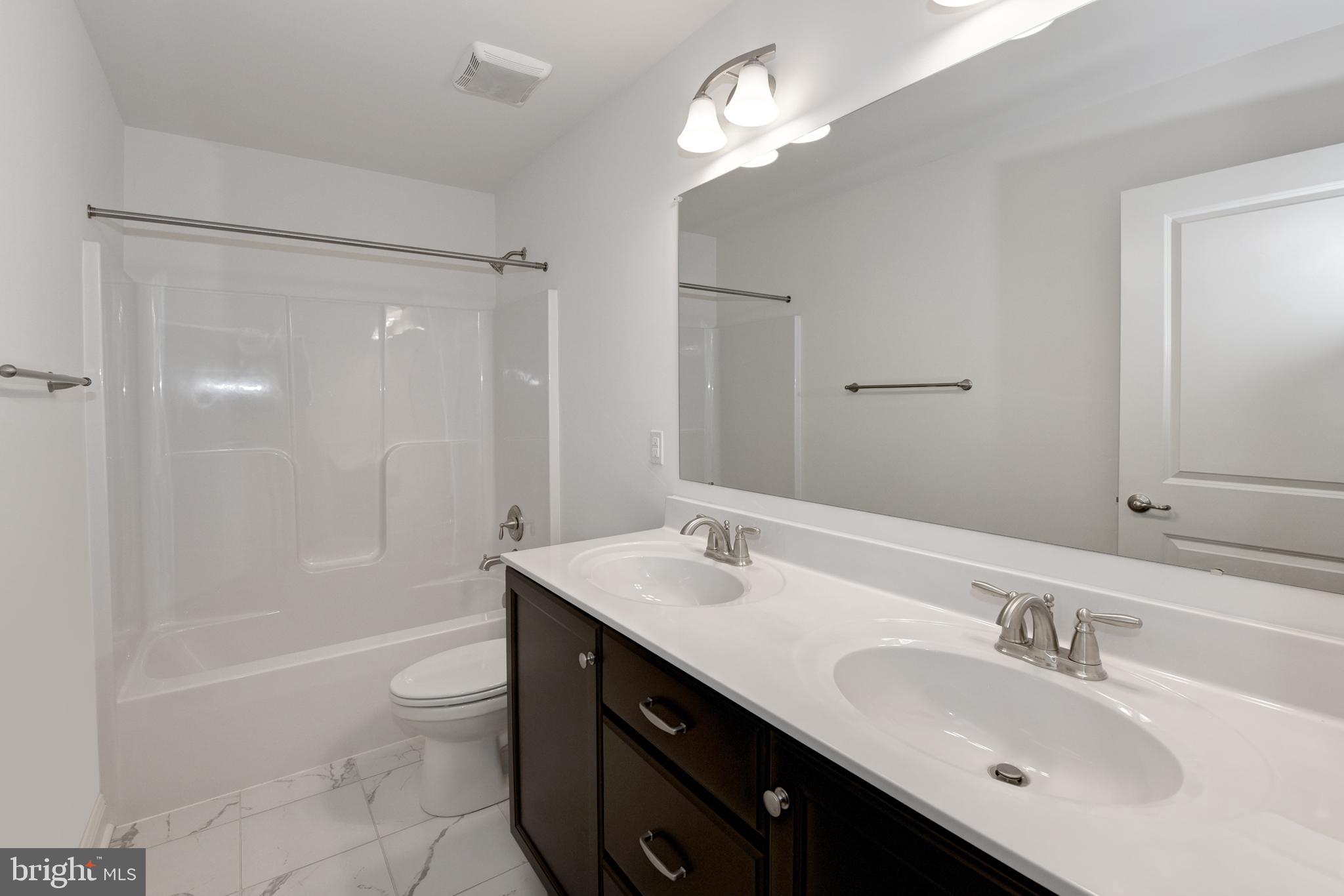 33 Seldon Drive, Unit 3 Smyrna, DE 19977 - Photo 13 of 24 a bathroom with a sink double vanity granite tub and a mirror
