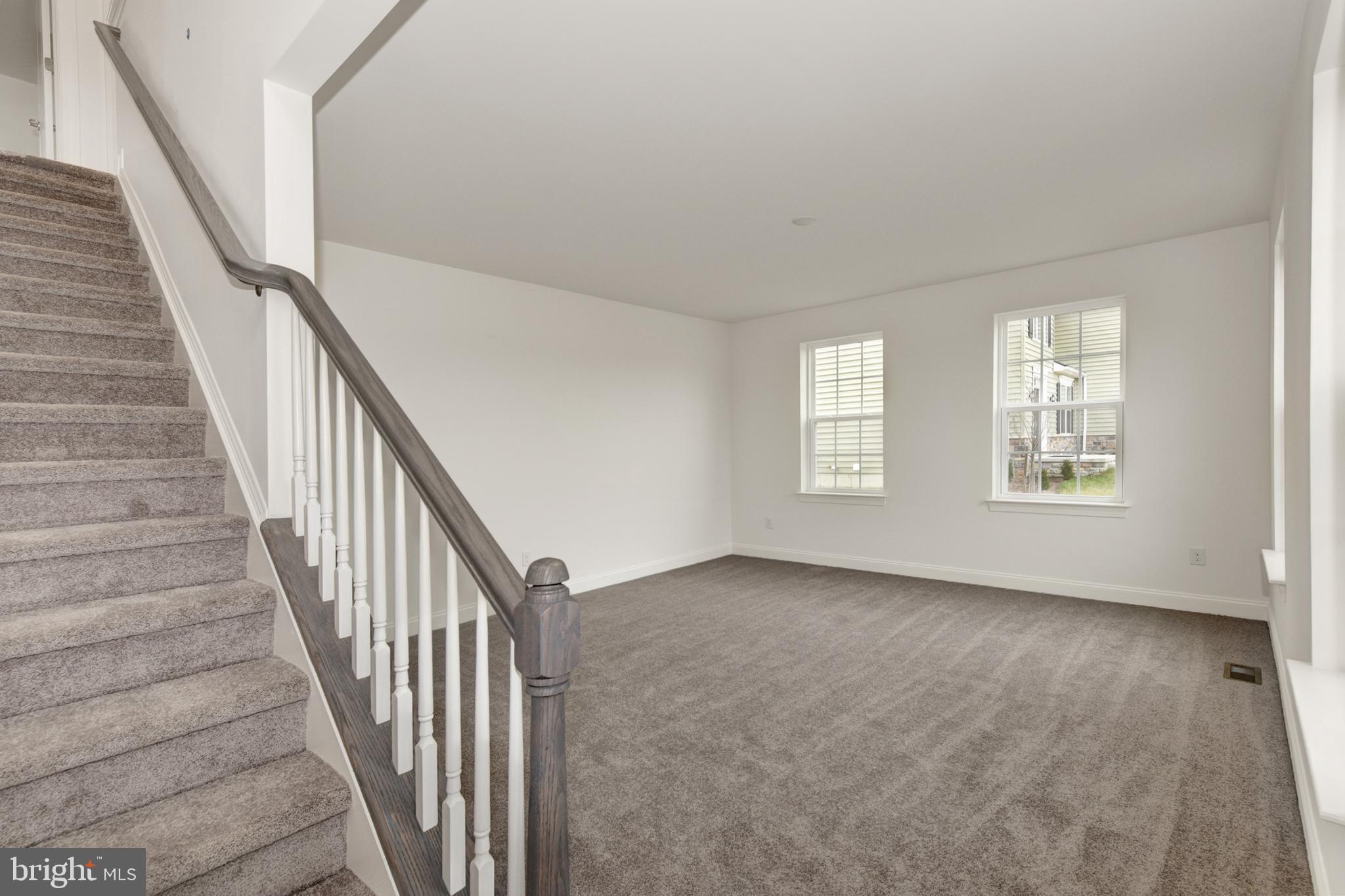 33 Seldon Drive, Unit 3 Smyrna, DE 19977 - Photo 5 of 24 a view of an empty room with wooden floor and stairs