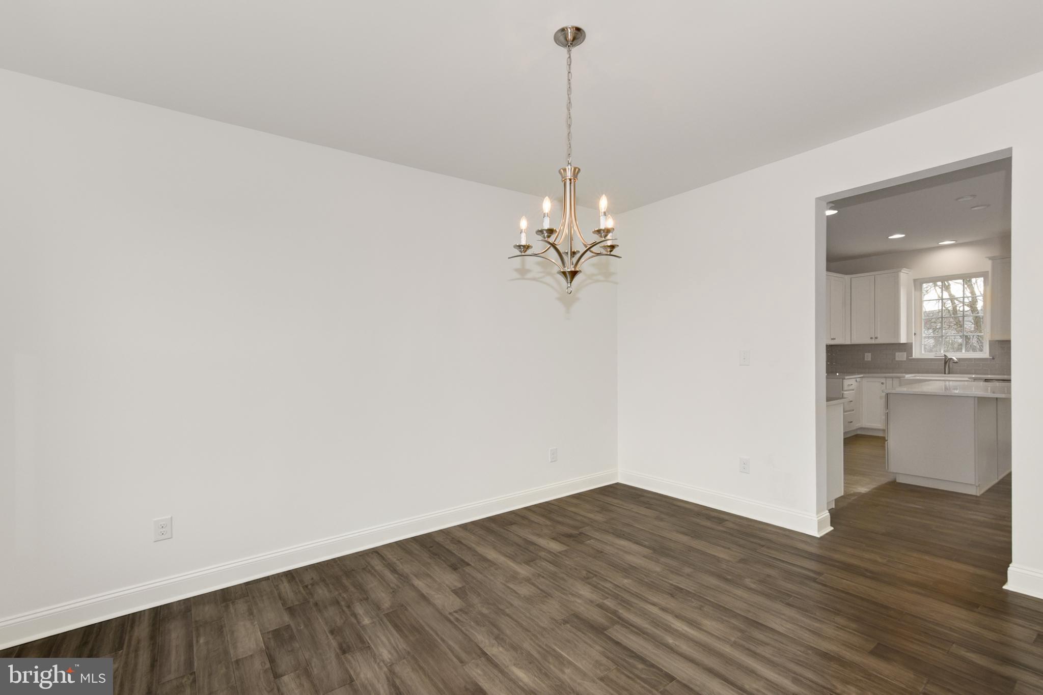 33 Seldon Drive, Unit 3 Smyrna, DE 19977 - Photo 6 of 24 a view of a room with wooden floor and kitchen view