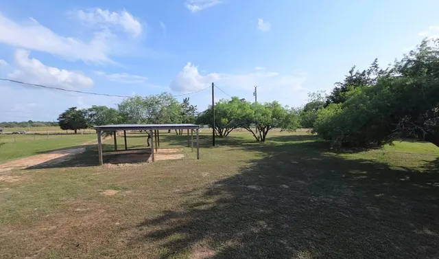 a view of outdoor space with deck and yard
