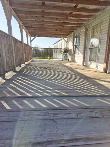 a view of porch with wooden floor