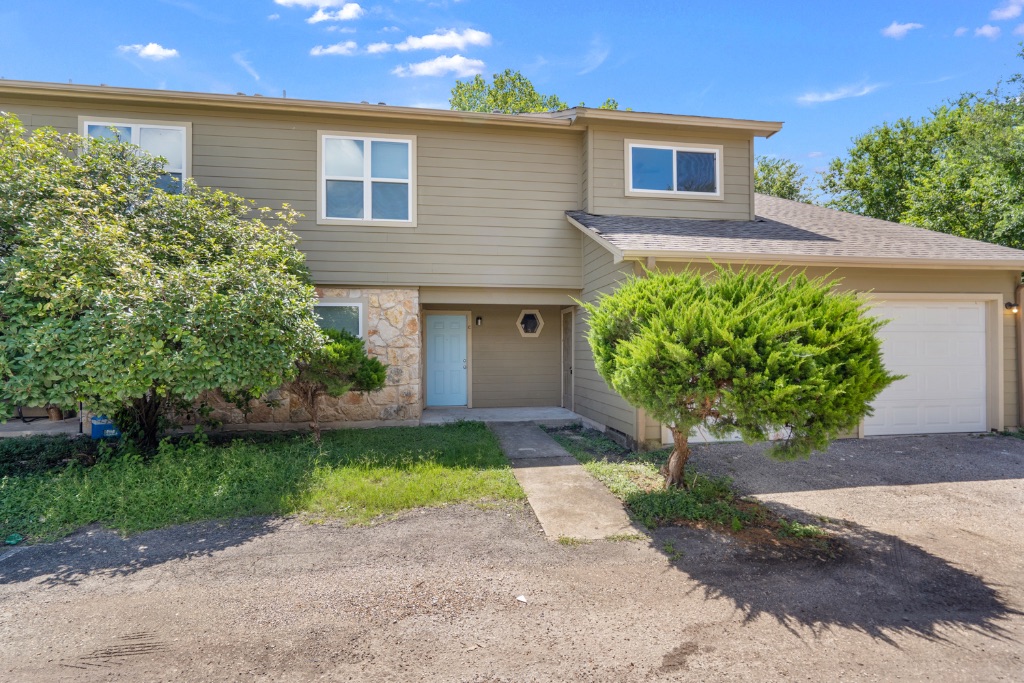 8703 Schick Road, Unit C Austin, TX 78729 - Photo 1 of 24 a front view of a house with garden