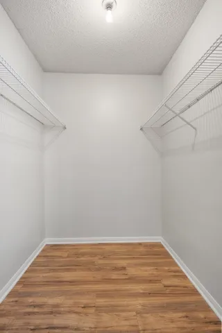 a view of a room with wooden floor