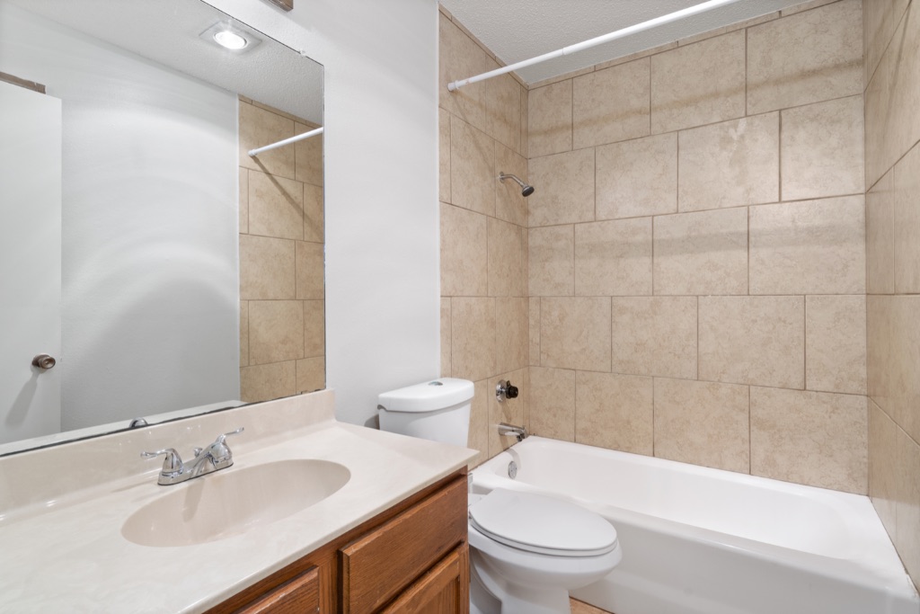 8703 Schick Road, Unit C Austin, TX 78729 - Photo 21 of 24 a bathroom with a sink a toilet and bathtub