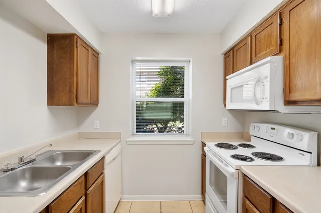 a kitchen with a stove a sink and a microwave