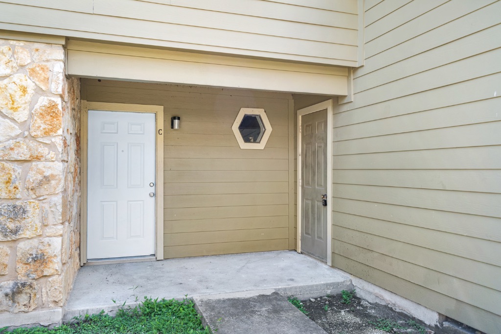 8703 Schick Road, Unit C Austin, TX 78729 - Photo 5 of 24 a front view of a house with a yard