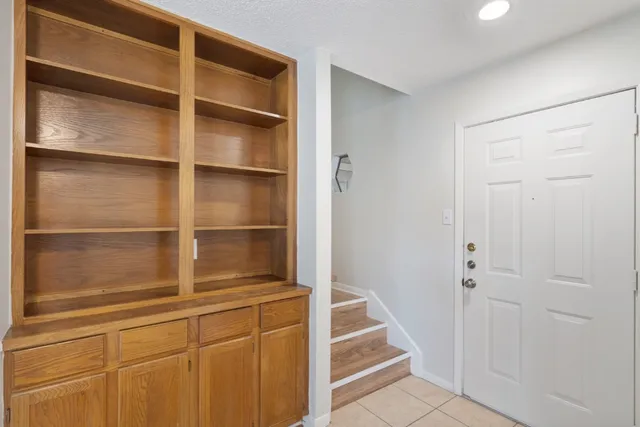 a kitchen with a white cabinets and a wooden floor