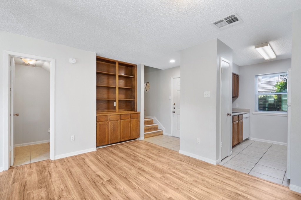 8703 Schick Road, Unit C Austin, TX 78729 - Photo 7 of 24 a view of an empty room with a kitchen