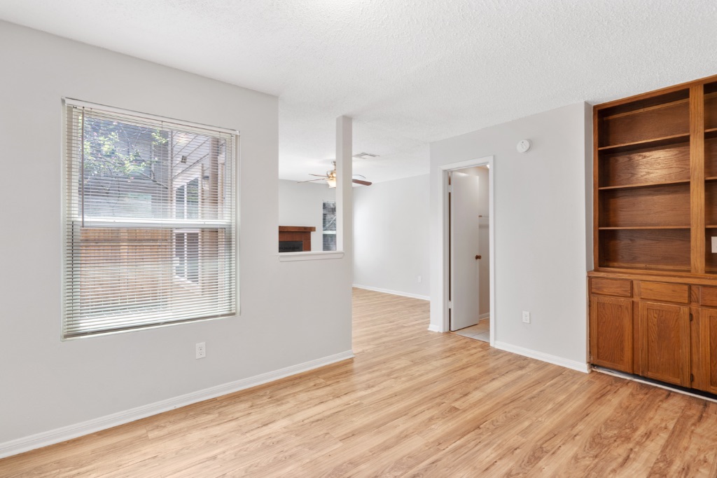8703 Schick Road, Unit C Austin, TX 78729 - Photo 8 of 24 a view of empty room with wooden floor and cabinet
