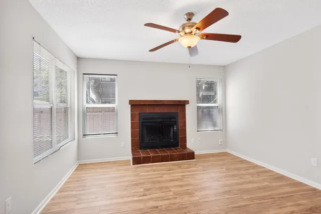 wooden floor fireplace and windows in a room