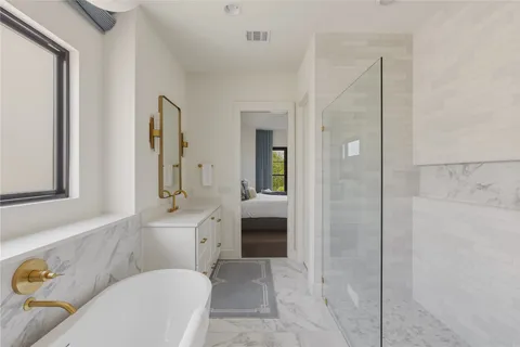 a bathroom with a granite countertop sink a toilet and shower