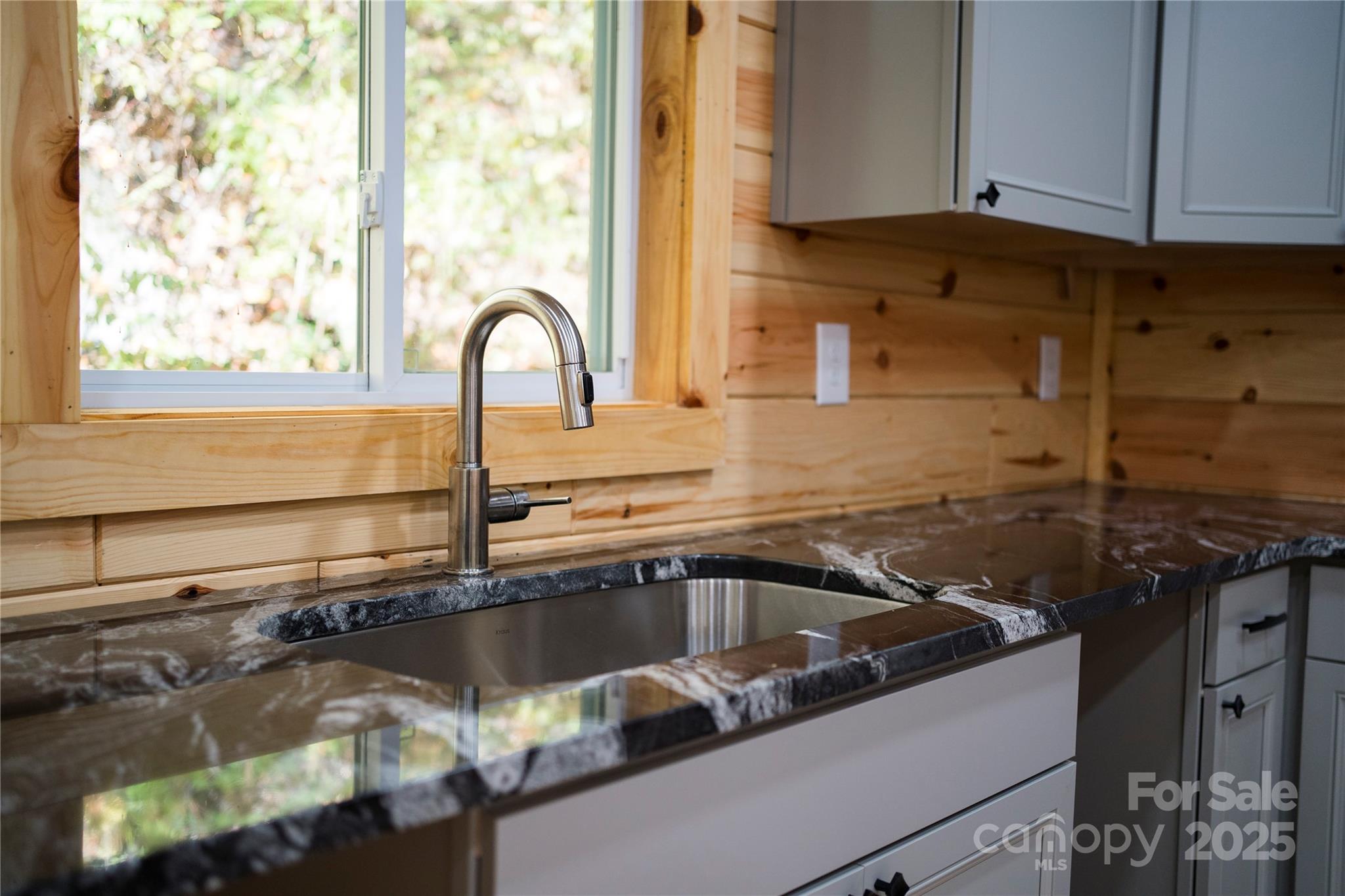 430 Long Branch Road Maggie Valley, NC 28751 - Photo 18 of 34 a close view of a sink a counter and appliances in the kitchen