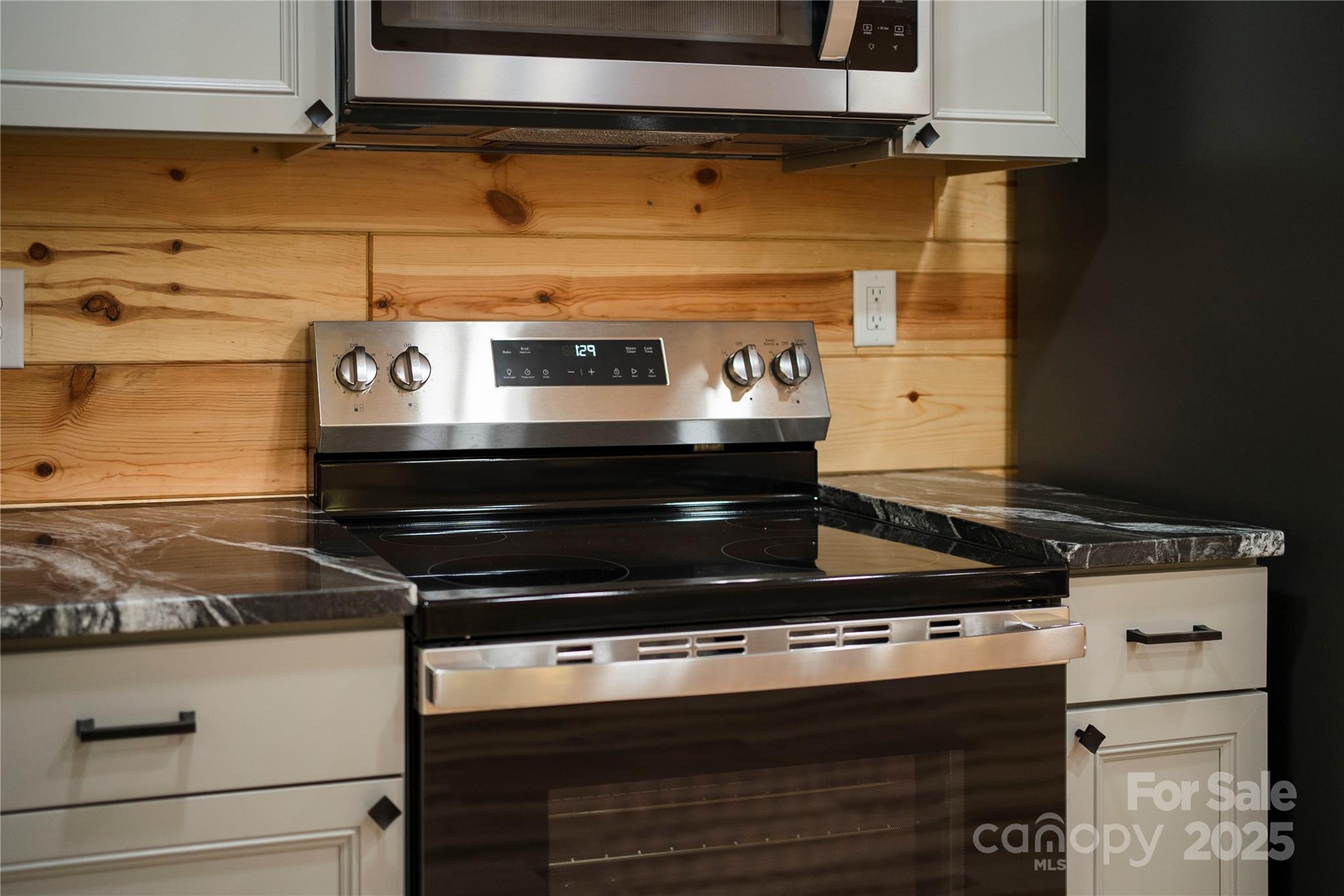 430 Long Branch Road Maggie Valley, NC 28751 - Photo 20 of 34 a stove top oven sitting inside of a kitchen