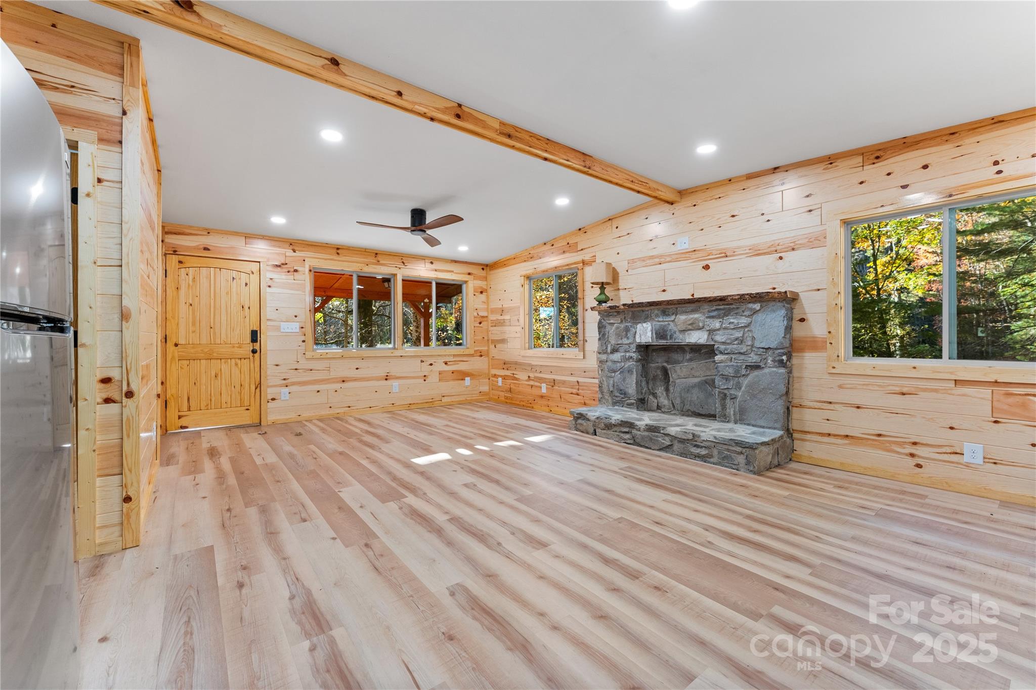 430 Long Branch Road Maggie Valley, NC 28751 - Photo 7 of 34 a view of an empty room with a fireplace and a window