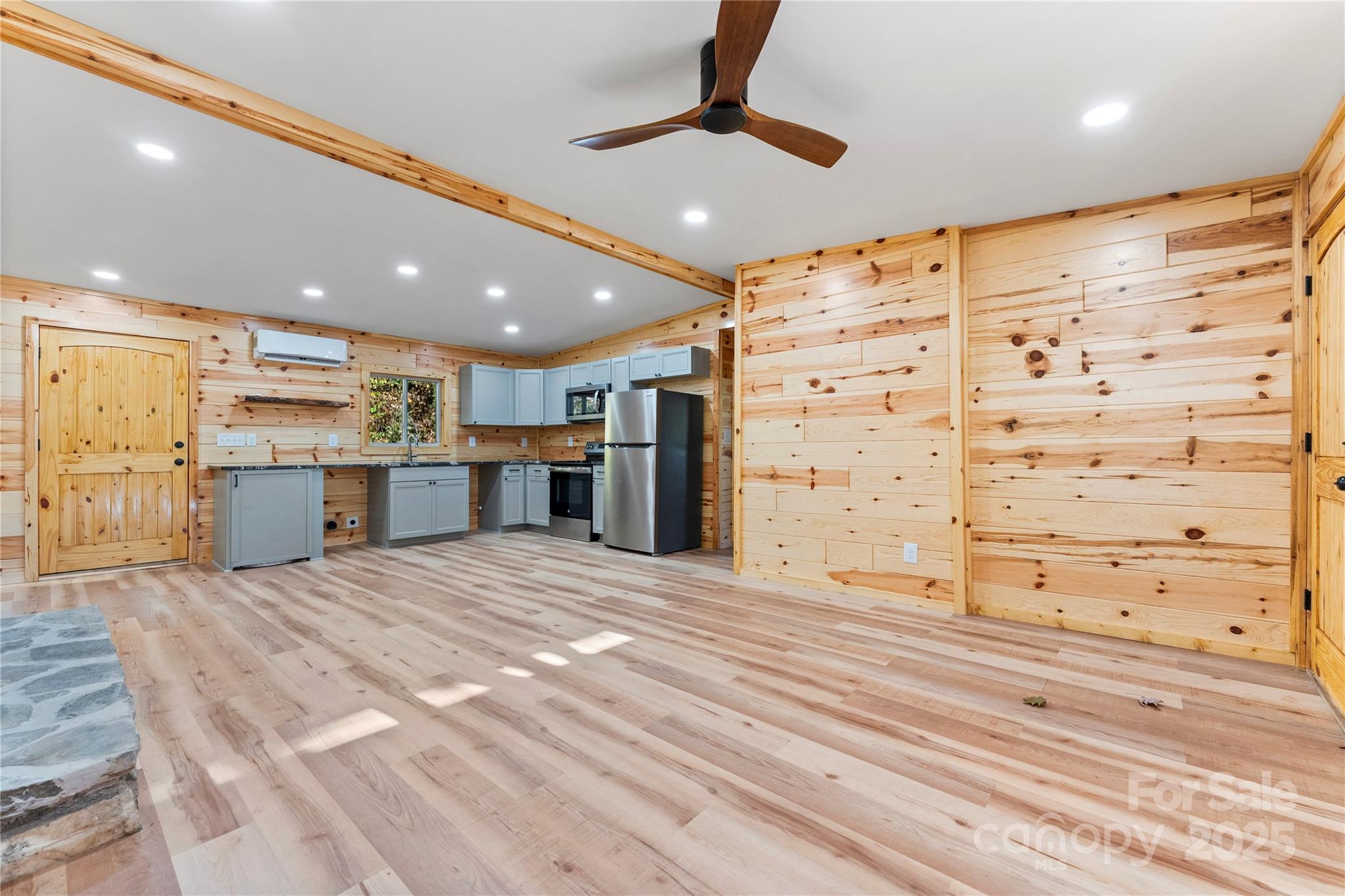 430 Long Branch Road Maggie Valley, NC 28751 - Photo 8 of 34 a view of kitchen with refrigerator stove and wooden floor