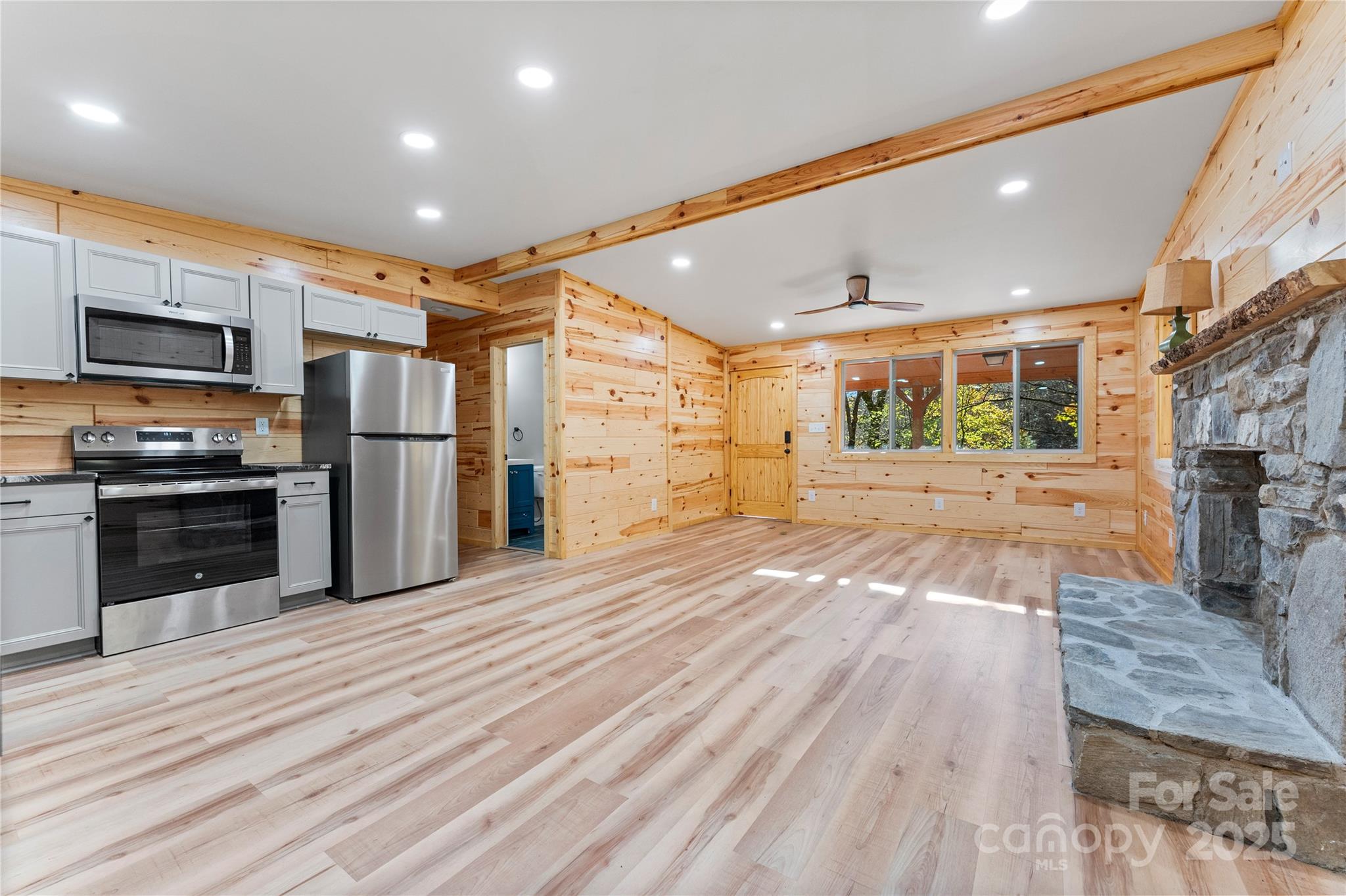 430 Long Branch Road Maggie Valley, NC 28751 - Photo 9 of 34 a large kitchen with stainless steel appliances kitchen island a large counter top and oven