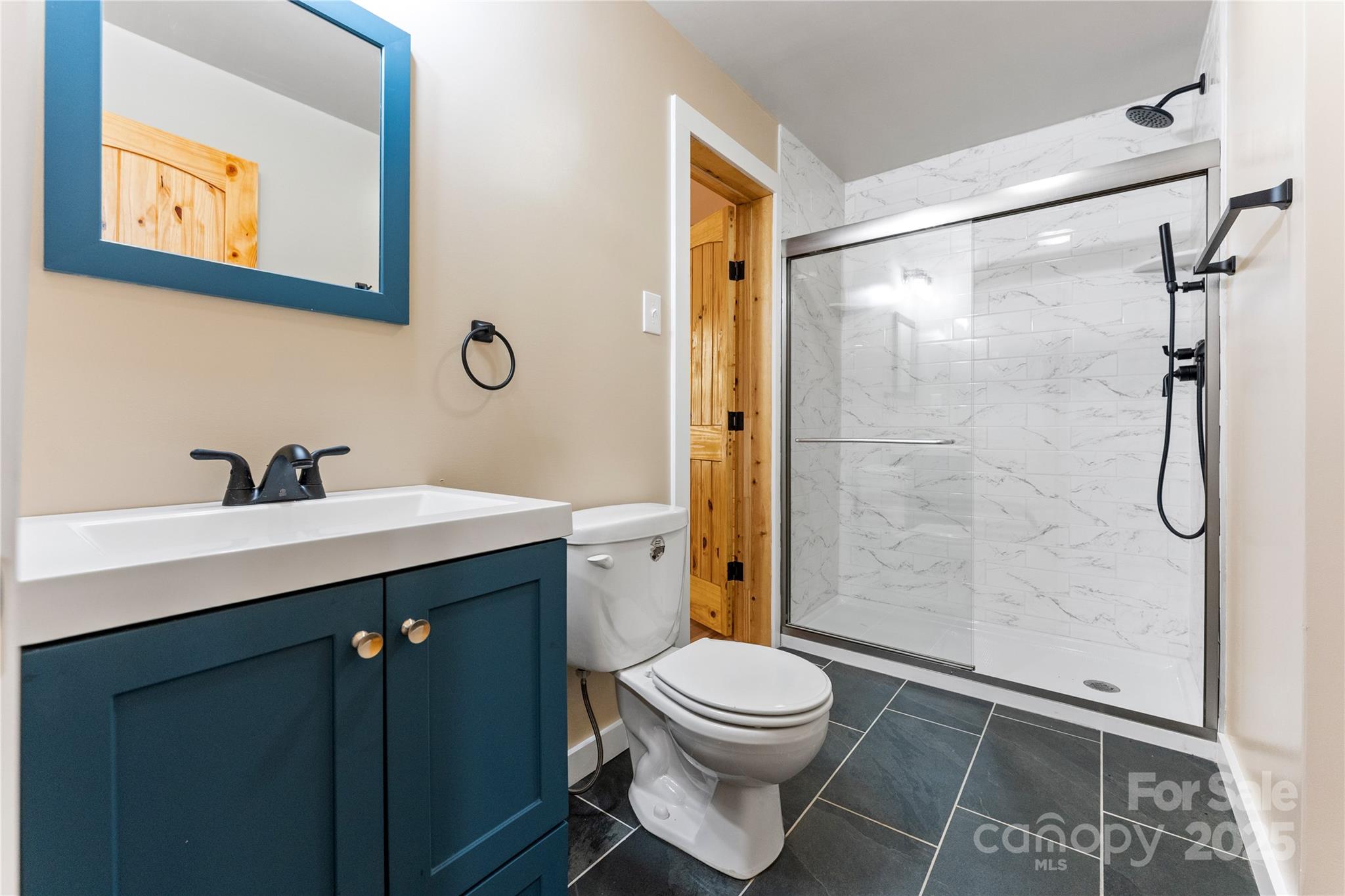 430 Long Branch Road Maggie Valley, NC 28751 - Photo 10 of 34 a bathroom with a sink mirror vanity and toilet