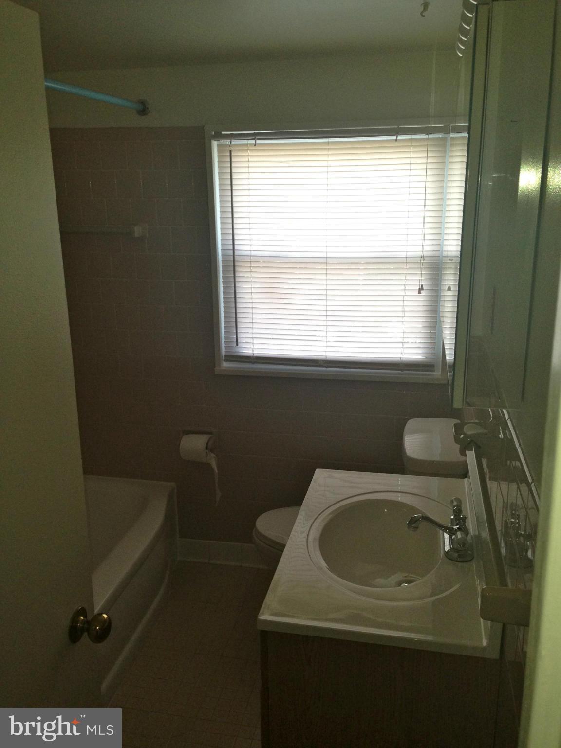 2739 Kirkleigh Road Baltimore, MD 21222 - Photo 15 of 30 a bathroom with a sink toilet and tub