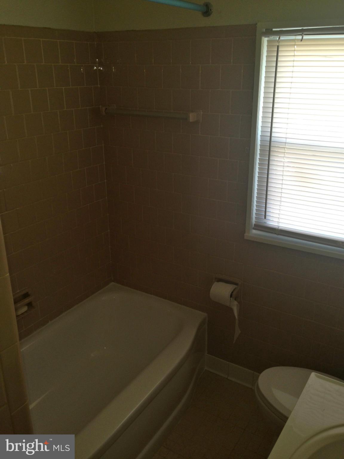 2739 Kirkleigh Road Baltimore, MD 21222 - Photo 16 of 30 a bathroom with a toilet and a window