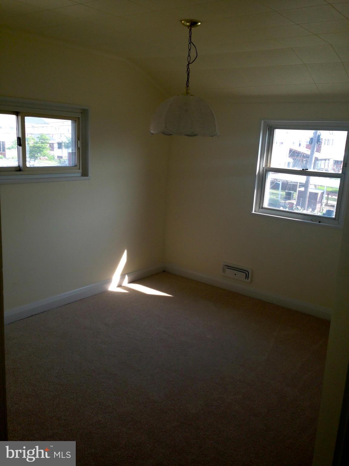 2739 Kirkleigh Road Baltimore, MD 21222 - Photo 18 of 30 a view of empty room with windows