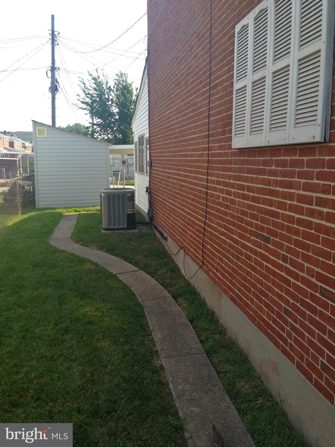 2739 Kirkleigh Road Baltimore, MD 21222 - Photo 20 of 30 a view of a house with a backyard