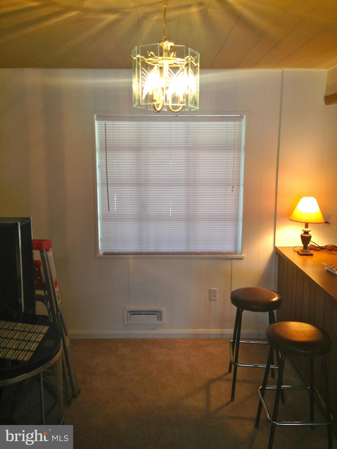 2739 Kirkleigh Road Baltimore, MD 21222 - Photo 7 of 30 a view of a room with a chandelier and wooden floor